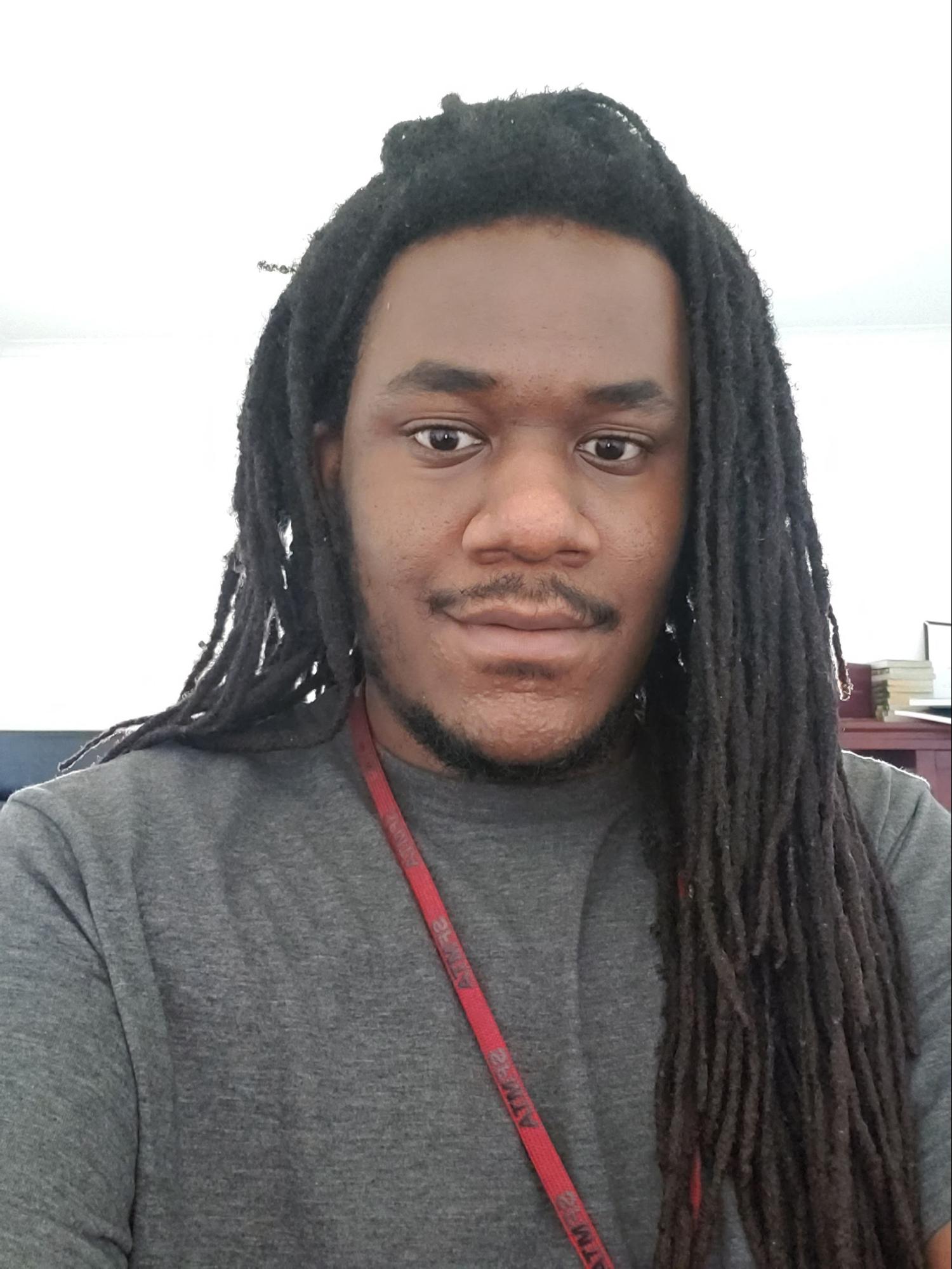 DeMian Williams, a 27-year-old Black-American male looking at the camera and smiling.