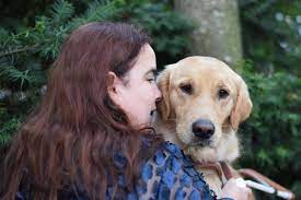 Profile image of Maia with her guide dog Gleam, photo by Anna Wilke.